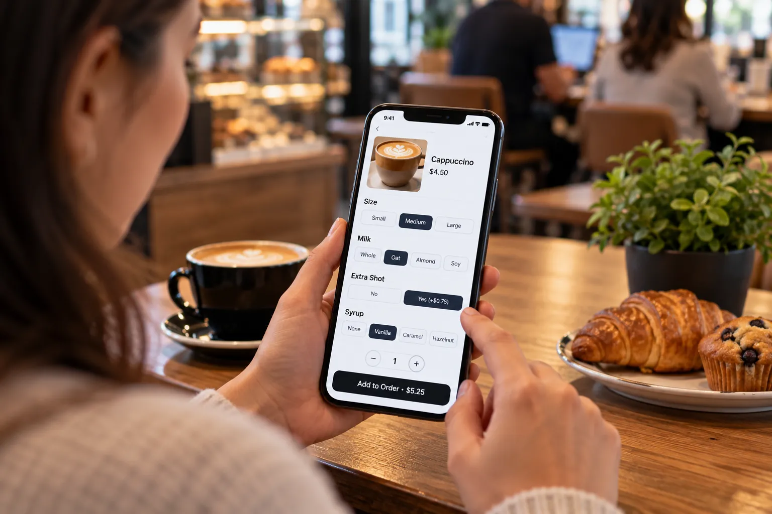 Cafe customer customizing a coffee order on mobile