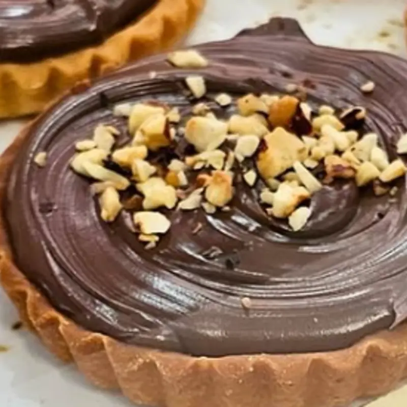 A "crostata alla Nutella" (Nutella tart) is a delicious Italian dessert featuring a buttery pastry crust filled with Nutella, a chocolate hazelnut spread, often topped with a lattice of dough.