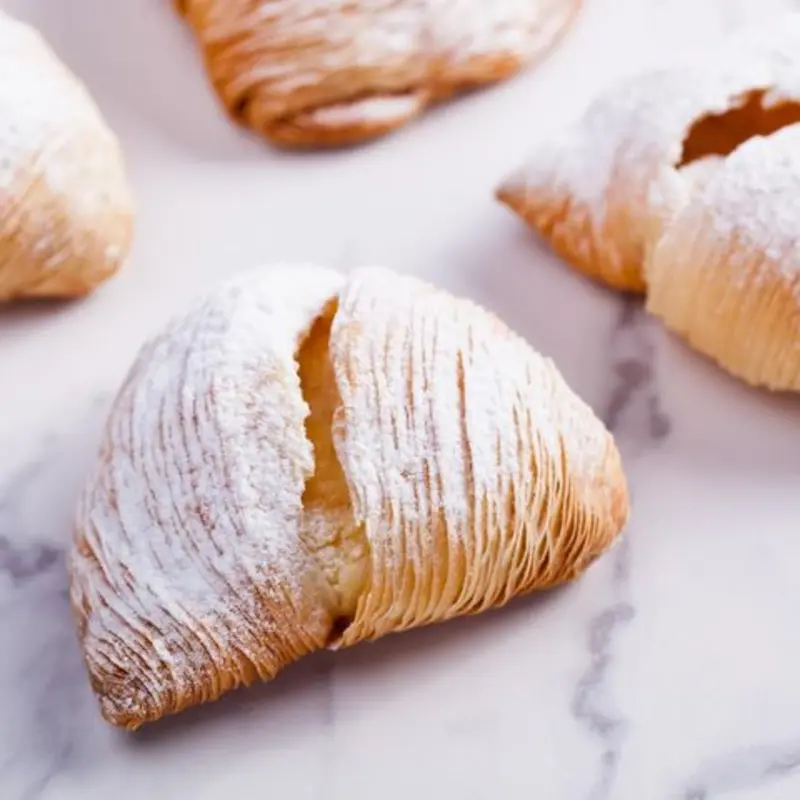 Crisp puff pastry filled with ricotta cheese and candied orange cubes