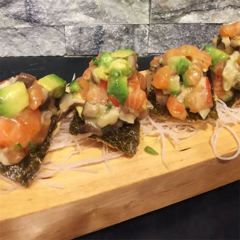 Salmon, avocado, shiitake mushroom, honey miso, and crispy seaweed. (Raw)(Spicy) at Ku Asian Bistro 480 New Rochelle Rd | Toast