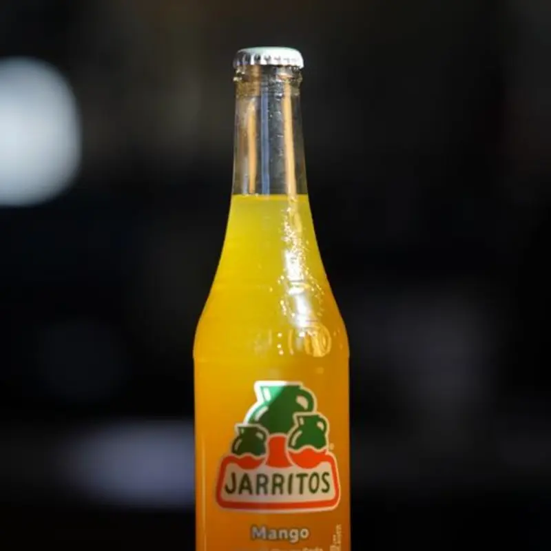 Jarritos Mango is a sweet, refreshing soda with a rich, tropical mango flavor, offering a bold and fruity taste. at The Station Cafe | Toast