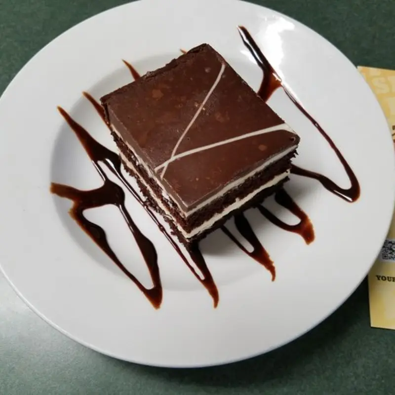 a generous layer of Belgian white chocolate mousse between two layers of dark chocolate sponge cake topped with chocolate ganache, you won’t believe it’s gluten free! / 12 Slices