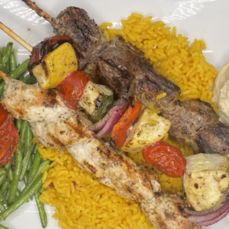 Chicken & Steak marinated in our tantalizing Mediterranean sauce and veggies skewered, grilled and served with seasoned rice, hummus & green beans. Served with a side salad
