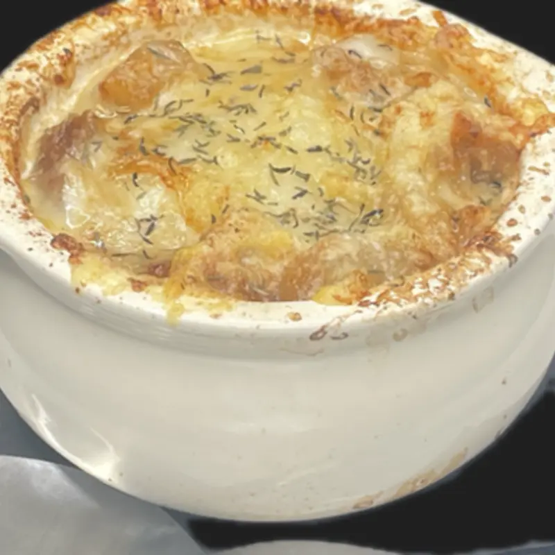 Rich caramelized onions in a savory broth, topped with melted Gruyère & mozzarella and toasted bread at Tilted Kilt Laredo #261 | Toast
