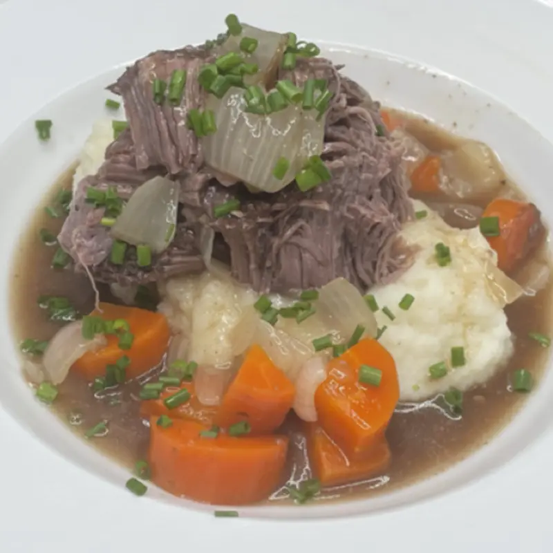 Slow-cooked pot roast, onions, carrots & gravy atop a bed of mashed potatoes. Served with a side salad. at Tilted Kilt Laredo #261 | Toast