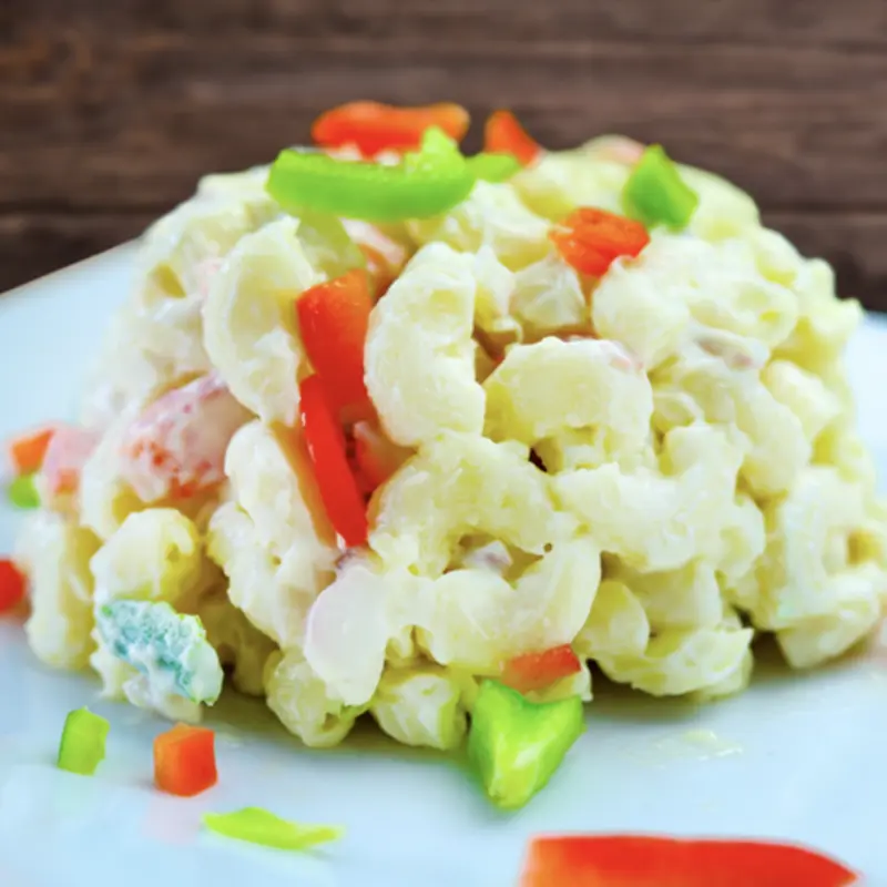 Chilled elbow macaroni mixed with creamy mayonnaise, red and green bell peppers, and savory seasonings.
