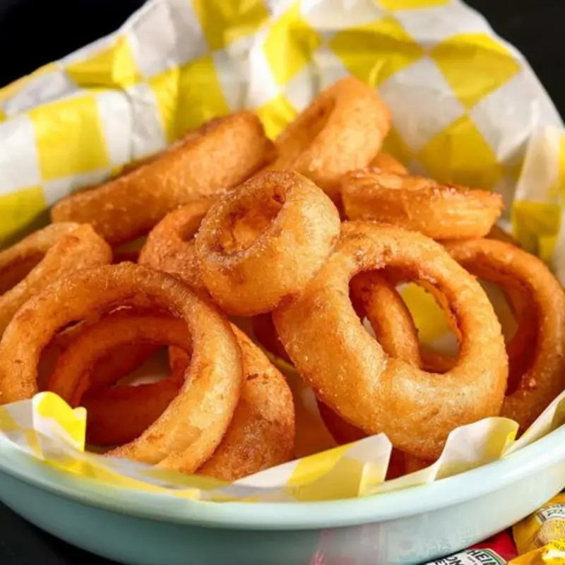 Crispy on the outside and tender on the inside these onion rings are fried to perfection. Enjoy them as a tasy snck or the perfect side to any meal. Don't forget the sauce! at Johnny Good Burger | Toast