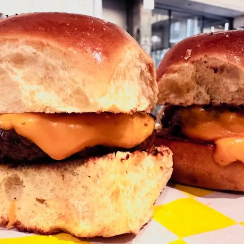 Two perfectly sized sliders featuring juicy 2oz beef patties, topped with melted American cheese and served on buttery slider buns. These little bites pack big flavor, making them an irresistible option for a quick snack or a lighter meal. Enjoy the same quality and taste of our larger burgers in a smaller, hand-held size.