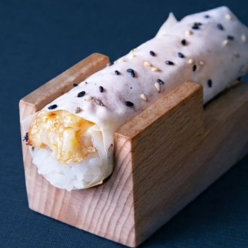Baked snow crab topped with crab mayo wrapped in soy paper at OMAKAI hand roll bar Brickell | Toast