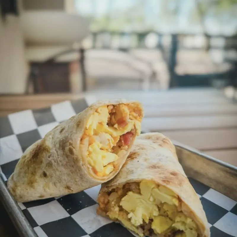 MAGIC BREAKFAST BURRITO (egg, tots, cheese, bacon, creamy chipotle)